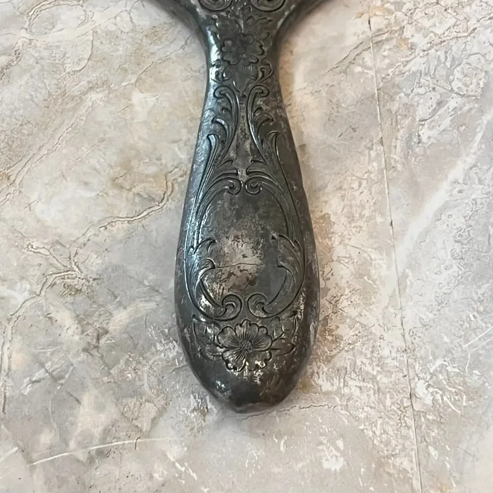 Silver Plated Hand Held Mirror with Intricate Raised Floral Scrollwork